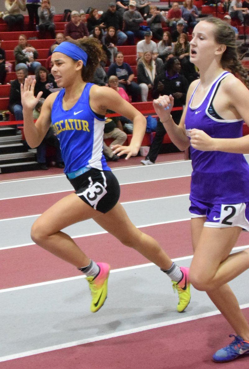 Westside Eagle Observer/MIKE ECKELS Decatur's Desi Meek pushes past another runner on the home stretch of the girls 400-meter run during the Arkansas High School Indoor Track Meet held at the Tyson Indoor Track Complex in Fayetteville Feb. 23.