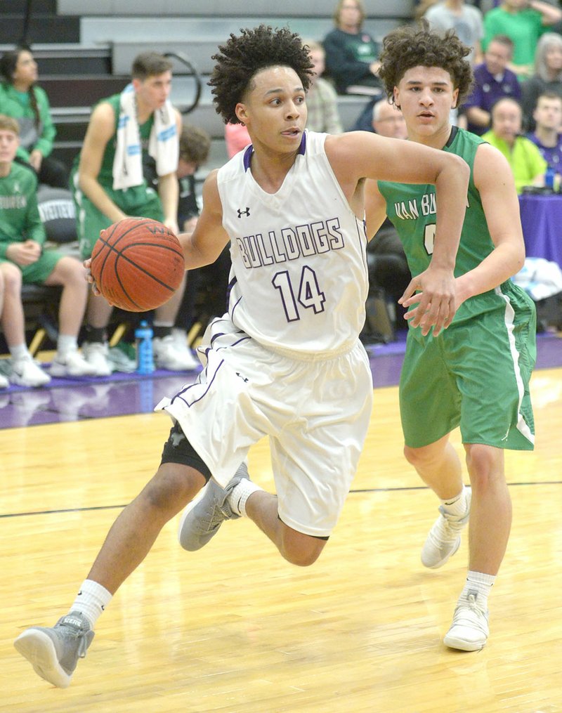 NWA Democrat-Gazette/ANDY SHUPE Collin Cooper (14) of Fayetteville drives past Zane West of Van Buren on Friday at Bulldog Arena in Fayetteville.