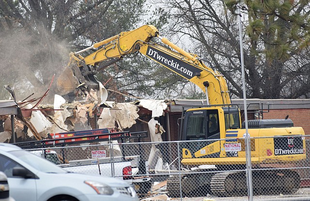 An excavator takes a bite out of the roof of the old Decatur Elementary building in Decatur Feb. 21. The demolition of the old classroom and office area will make way for the new Decatur Middle School gym.