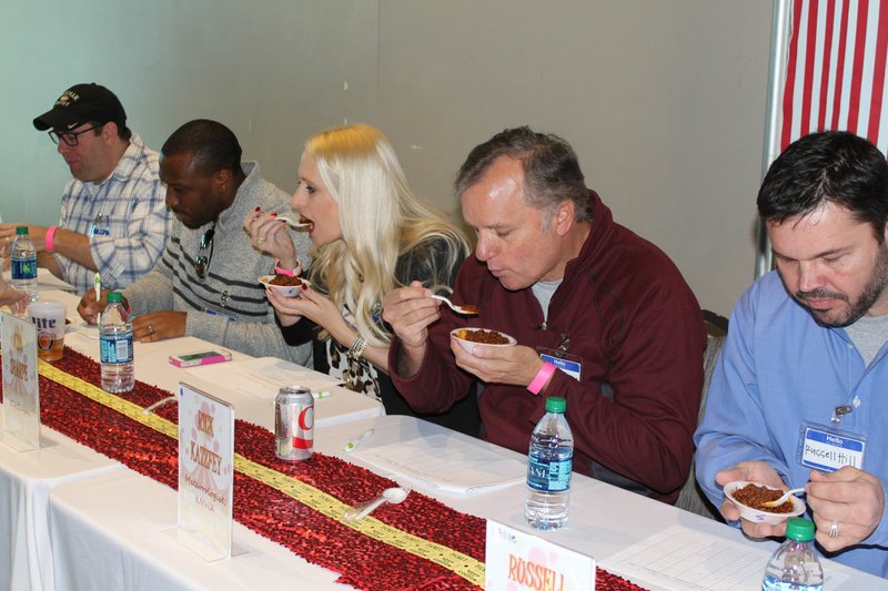 Courtesy photo Judges test chilis at a past Chilirhea chili contest and fundraiser. The 13th annual event will be March 10 at the Washington County Fairgrounds in Fayetteville.