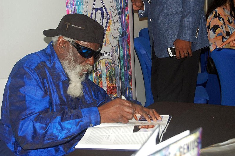 Arkansas Democrat-Gazette/HELAINE R. WILLIAMS

Jazz saxophonist Pharoah Sanders autographs a book at the Arkansas Black Hall of Fame Distinguished Laureate Series VII, featuring inductee Sanders, Feb. 24, 2018, at University of Arkansas-Pulaski Technical College's Center for Humanities and Arts in North Little Rock.