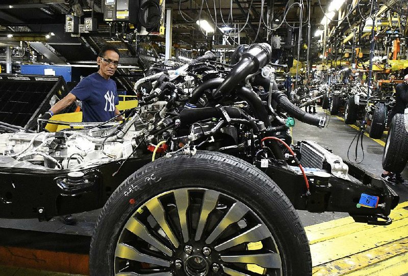 Workers assemble Ford trucks in October at a plant in Louisville, Ky. On Thursday, the Institute for Supply Management said its manufacturing index rose to 60.8 in February from 59.1 in January.