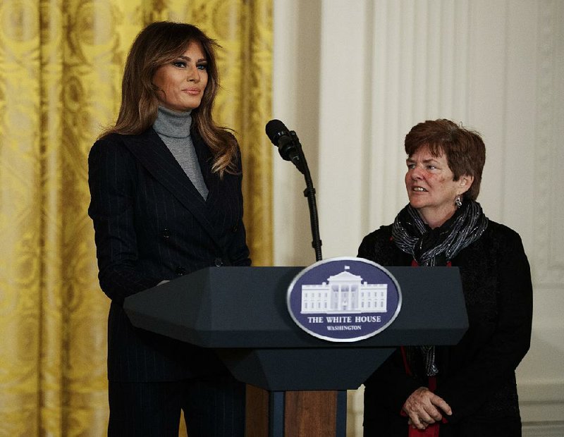 First lady Melania Trump is joined by Betty Henderson of North Fort Myers, Fla., at a White House gathering Thursday on the opioid crisis. The first lady opened the forum by reading part of a letter from Henderson, who lost her 29-year-old son to drugs in September.