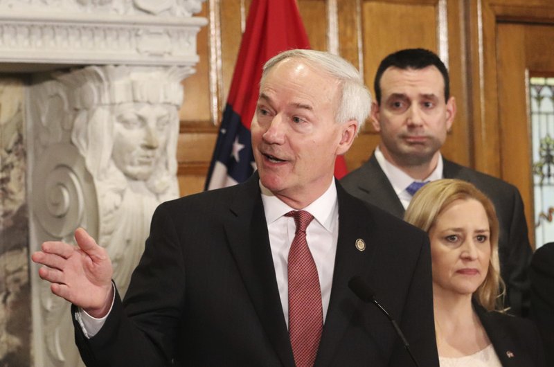 Gov. Asa Hutchinson speaks during a news conference announcing the establishment of a committee to study school safety issues Thursday in Little Rock. Hutchinson named school officials and people with law enforcement backgrounds to the panel in response to last month's school shooting in Florida. (AP Photo/Kelly Kissel)