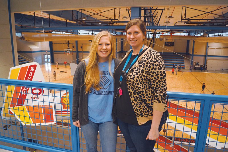 Katelyn Hamilton, left, and Krystal Askew, right, stand in the gymnasium of the Boys & Girls Clubs of Saline County’s Riverside Club. Hamilton is the club’s Youth of the Year, and Askew is program administrator.