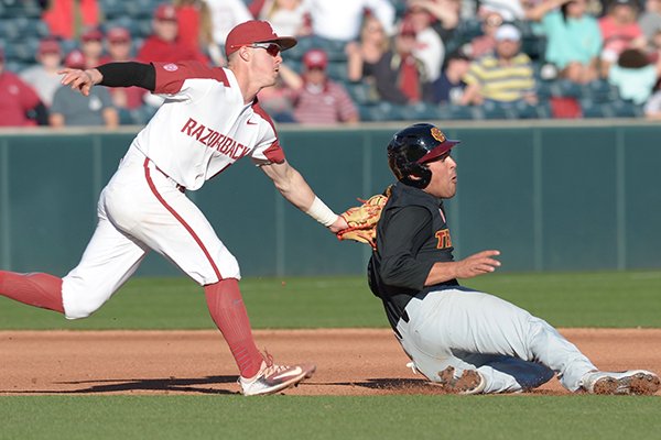 Arkansas third baseman Casey Martin tags Southern Cal base runner Angelo Armenta during a game Friday, March 2, 2018, in Fayetteville. 