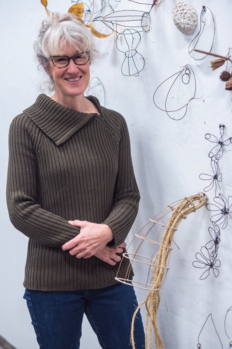 Holly Laws, associate professor of art at the University of Central Arkansas, has been selected as the Arkansas representative to the international exhibit Heavy Metal: Women to Watch 2018 at the National Museum of Women in the Arts in Washington, D.C. An instructor of 3-D design at UCA, she is shown here with wire sculptures she shows her students as they begin her class.
