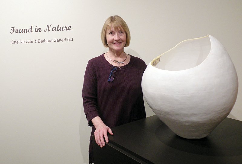 Barbara Satterfield stands beside a very large piece of her ceramic sculpture she calls Rim. A look on the inside shows a press mold she created from a dirt-dauber’s nest. The exhibit, Found in Nature: Kate Nessler and Barbara Satterfield, will remain on display at the Historic Arkansas Museum in Little Rock until May 6