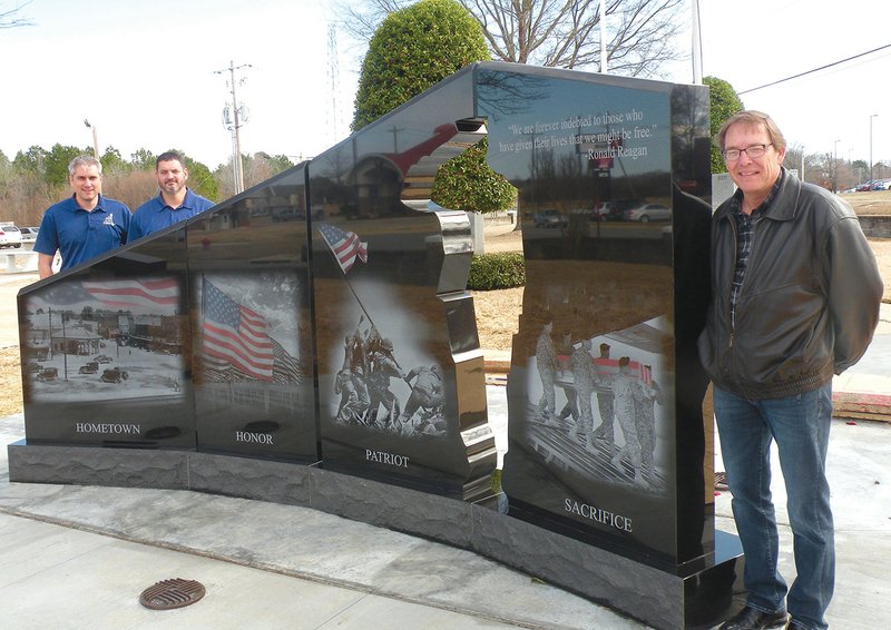 The community of Beebe dedicated the Gold Star Families Memorial Monument on Feb. 23 in Beebe Veterans Park. Showing one side of the monument to visitors on Tuesday are, from left, Jeff Marshall and Bubba Beason, co-chairmen of the Beebe Committee for the Gold Star Families Memorial Monument and honorary board members of the Hershel Woody Williams Medal of Honor Foundation, and Beebe Mayor Mike Robertson.