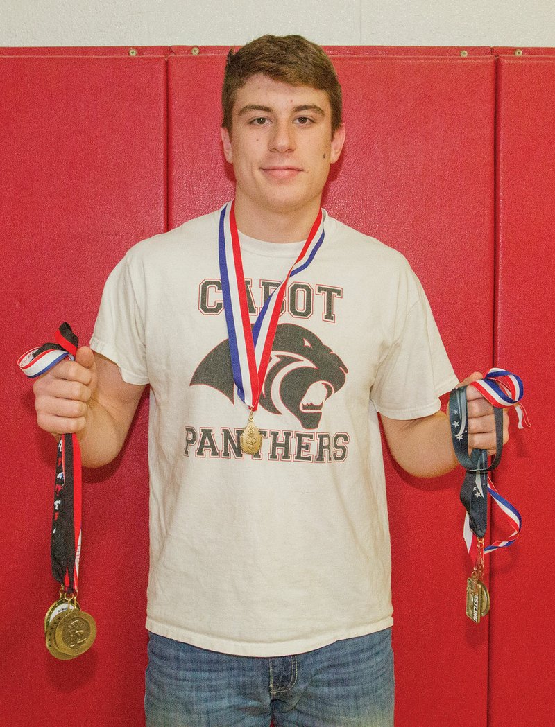 Cabot Panthers wrestler C.J. Long shows the medals he won during the 2017-18 season. Long, who finished the season 44-3, won the Class 6A-7A state championship in the 195-pound weight class.