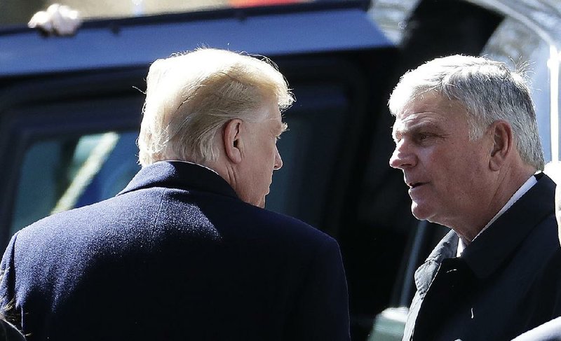 President Donald Trump speaks Friday with Franklin Graham, son of the Rev. Billy Graham, after the funeral for the world-renowned evangelist in Charlotte, N.C. 