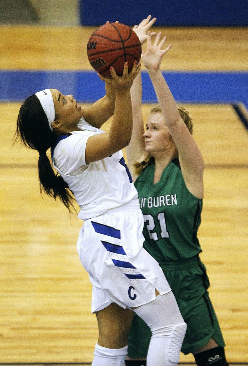 Conway’s Myla Yelder (left) puts up a shot over Van Buren’s Rylee Ryan (21) during the Lady Wampus Cats’ 60-38 victory over the Lady Pointers on Friday at the Class 7A girls state tournament in North Little Rock. See more photos at arkansasonline.com/galleries