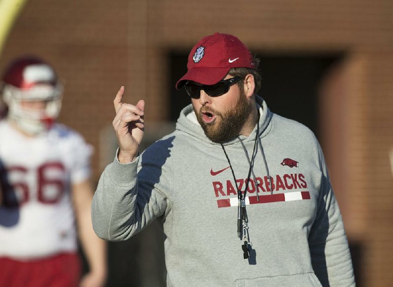 NWA Democrat-Gazette/BEN GOFF @NWABENGOFF
Dustin Fry, Arkansas offensive line/run game coordinator, runs a drill Thursday, March 1, 2018, during Arkansas spring football practice at the Fred W. Smith Football Center in Fayetteville. 