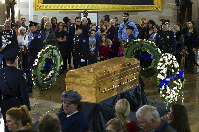 Visitors pay their respects Wednesday as the casket of the late Rev. Billy Graham lies in honor at the Capitol rotunda in Washington. Graham, 99, died Feb. 21 at his North Carolina home.  
