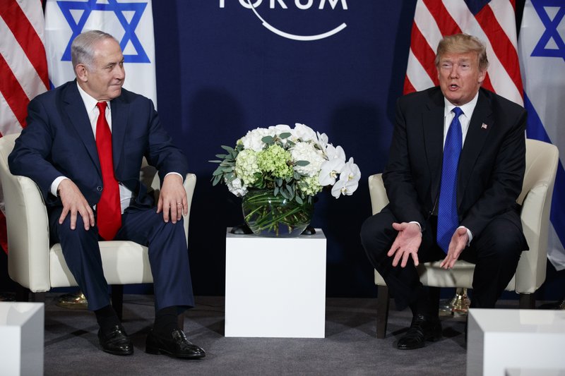 FILE- in this file photo dated Thursday, Jan. 25, 2018, President Donald Trump, left, speaks during a meeting with Israeli Prime Minister Benjamin Netanyahu at the World Economic Forum, Thursday, Jan. 25, 2018, in Davos, Switzerland. Netanyahu and Trump will meet upcoming Monday March 5, 2018, and the two elected leaders share strikingly similar circumstances, as they are both at loggerheads with their countries' establishments, holding on, despite their individual scandals. (AP Photo/Evan Vucci, FILE)