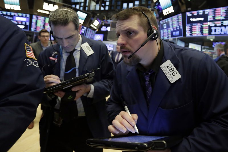 Traders Gregory Rowe, left, and Michael Milano work on the floor of the New York Stock Exchange, Friday, March 2, 2018. Stocks are opening lower Friday as investors remain concerned that President Donald Trump's plan to impose tariffs on steel and aluminum imports will lead to retaliation from other countries. (AP Photo/Richard Drew)