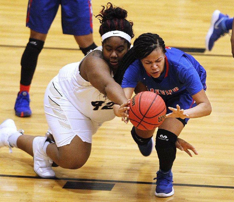 Trinity Nevels (left) of Hot Springs and Little Rock Parkview’s Jordyn Williams fight for a loose ball Saturday during the Lady Trojans’ 67-53 victory over the Lady Patriots in the semifinals of the Class 5A girls state tournament in Maumelle. 