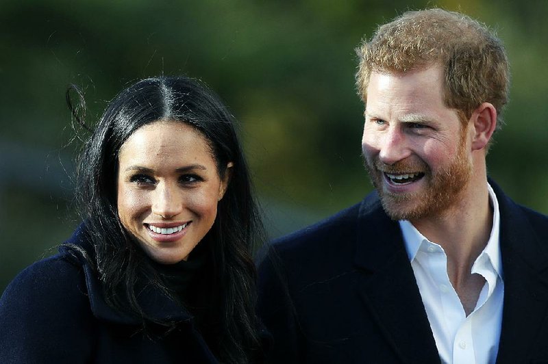 In this file photo dated Friday, Dec. 1, 2017, Britain's Prince Harry and his fiancee Meghan Markle, in Nottingham, England. 