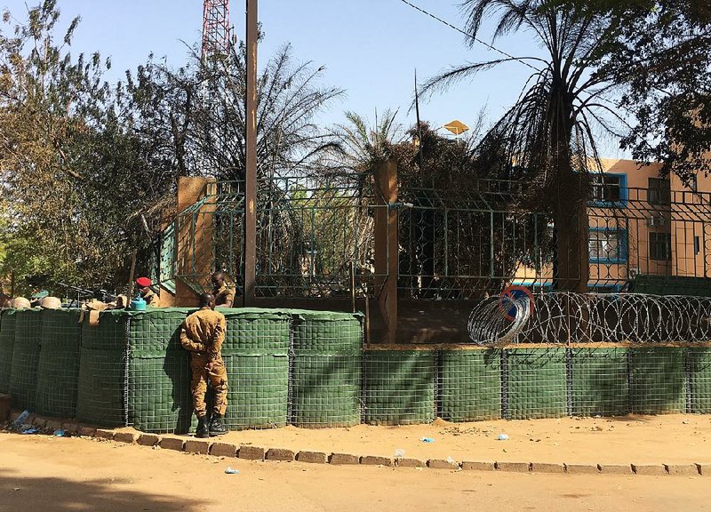 Security forces guard the armed forces general staff building Saturday in Ouagadougou, Burkina Faso, in the wake of Islamic extremist attacks last week.