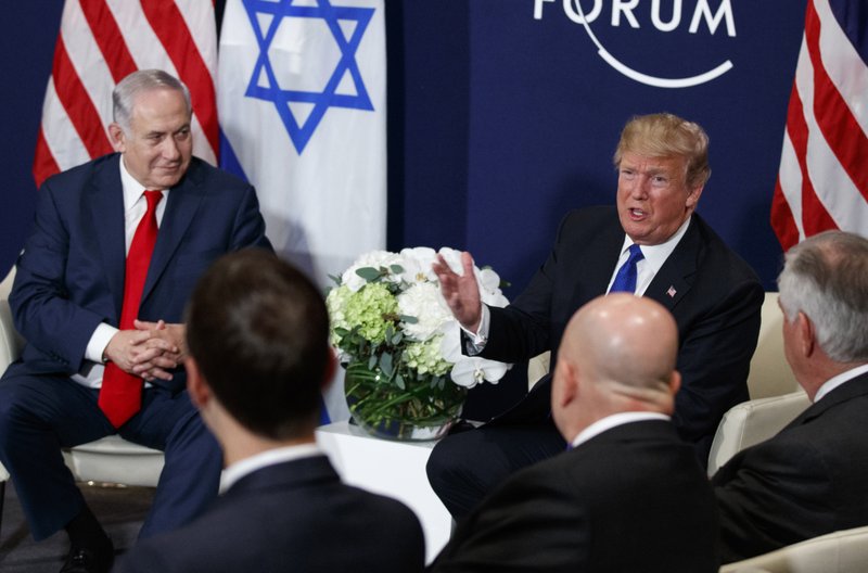 FILE - In this Jan. 25, 2018 file photo, Israeli Prime Minister Benjamin Netanyahu looks on as President Donald Trump speaks during a meeting at the World Economic Forum in Davos. In the foreground from left are White House senior adviser Jared Kushner, National Security Adviser H.R. McMaster and Secretary of State Rex Tillerson. Under the best of circumstances, brokering a Mideast peace deal is the holy grail of diplomacy. But as Israeli Prime Minister Benjamin Netanyahu comes to Washington, the circumstances today are far from ideal.  (AP Photo/Evan Vucci)