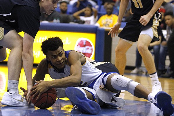 North Little Rock's Moses Moody (12) dives for a loose ball during a game against Bentonville West on Friday, March 2, 2018, in North Little Rock. 