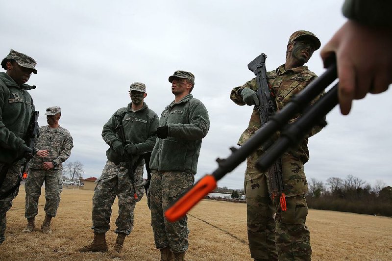 Cadet squad leader Brooks Boshears (center) gives instructions to fellow University of Central Arkansas ROTC cadets during a training exercise on Feb. 1 at the UCA intramural fi elds in Conway.