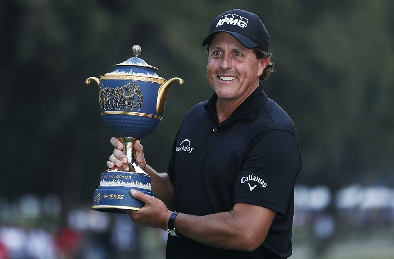Phil Mickelson, of the U.S., poses with his Mexico Championship trophy at the Chapultepec Golf Club in Mexico City, Sunday, March 4, 2018. 