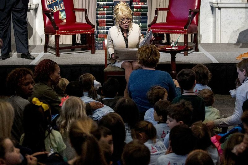 Singer-songwriter Dolly Parton reads her book Coat of Many Colors to children Tuesday at the Library of Congress in Washington. The Library of Congress celebrated the Imagination Library’s delivery of its 100 millionth book.