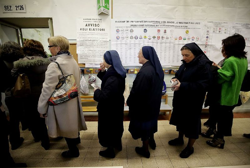 People line up at a polling station near the Vatican in Rome on Sunday.