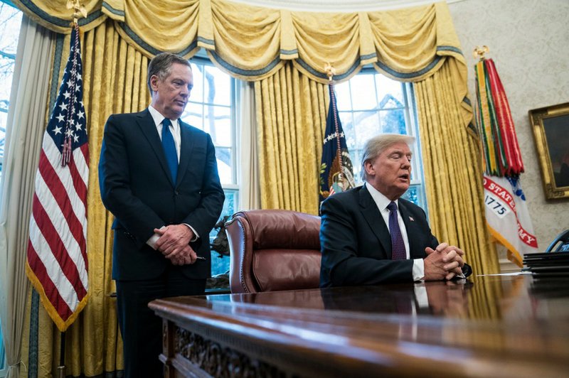 President Donald Trump, with U.S. Trade Representative Robert E. Lighthizer, speaks in the Oval Office on Jan. 23. 