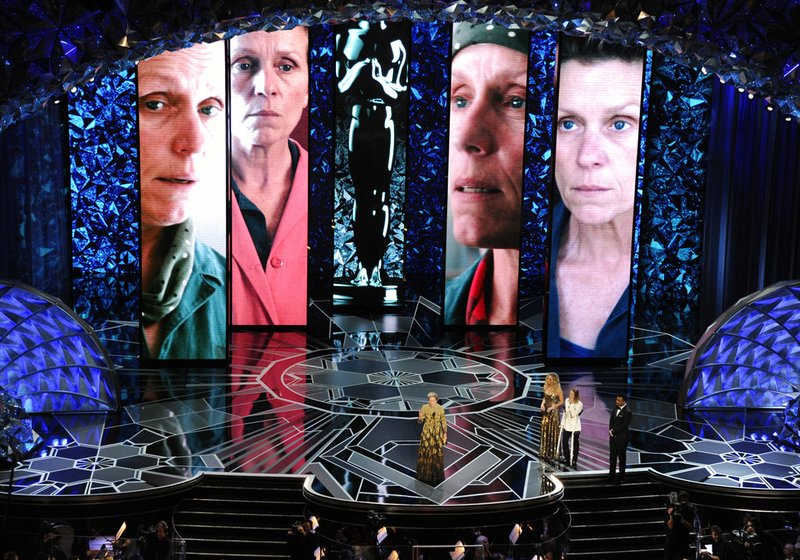 Frances McDormand accepts the award for best performance by an actress in a leading role for "Three Billboards Outside Ebbing, Missouri" as Jennifer Lawrence and Jodie Foster look on from right at the Oscars on Sunday, March 4, 2018, at the Dolby Theatre in Los Angeles. 
