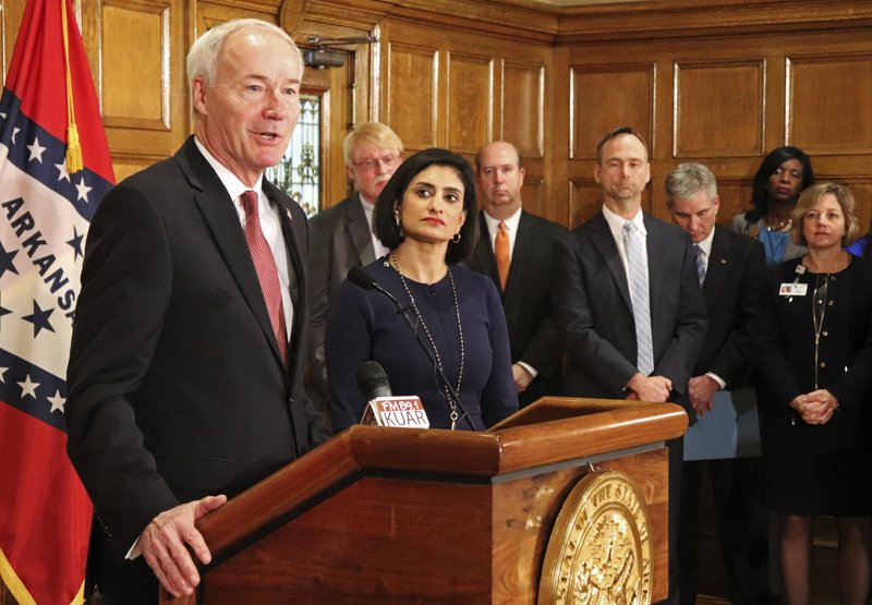 Gov. Asa Hutchinson speaks at a news conference Monday at the state Capitol in Little Rock, Ark., with Seema Verma, the head of the Centers for Medicare and Medicaid Services. Verma on Monday approved a state plan to require that thousands of people on its Medicaid expansion seek ways to work or volunteer. Traditional Medicaid recipients are not affected. Arkansas is the third state to win permission, following Kentucky and Indiana. (AP Photo/Kelly P. Kissel)