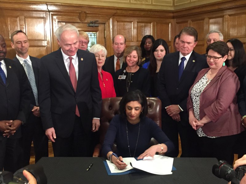 Seema Verma, administrator of the U.S. Centers for Medicare and Medicaid Services, signs a federal waiver allowing Arkansas to implement a work requirement on many of the recipients of the state’s private-option Medicaid expansion program on Monday, March 5, 2018.