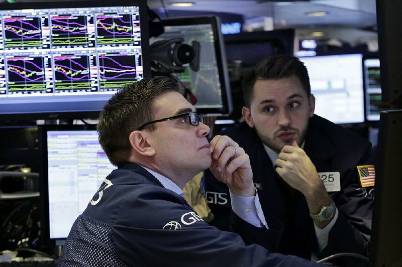 Specialists Robert Tuccillo (left) and Matthew Greiner work on the floor of the New York Stock Exchange on Monday. Major U.S. stock indexes closed sharply higher in a broad advance as concerns appeared to fade of the prospect of more protectionist trade policies.