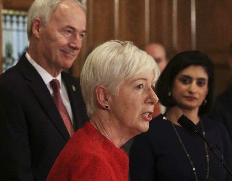 Arkansas Democrat-Gazette/STATON BREIDENTHAL --3/5/18-- Department of Human Services Director Cindy Gillespie (middle) talks Monday along with Gov. Asa Hutchinson (left) and Centers for Medicare and Medicaid Services Administrator Seema Verma  about a waiver to allow the state to implement a work requirement for Arkansas Works enrollees. 