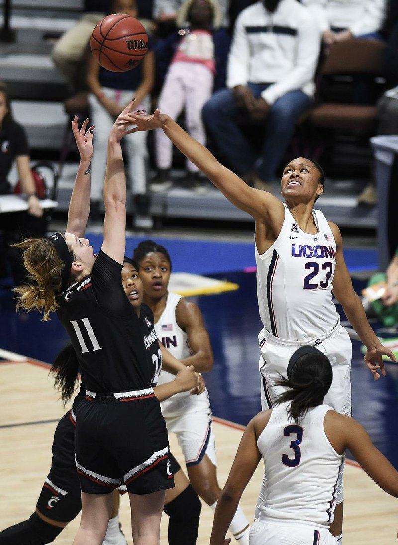 Cincinnati’s Sam Rodgers (11) shoots as Connecticut’s Azura Stevens (23) defends during Connecticut’s 75-21 victory over Cincinnati. Connecticut will play South Florida in the championship game of the American Athletic Conference Tournament.