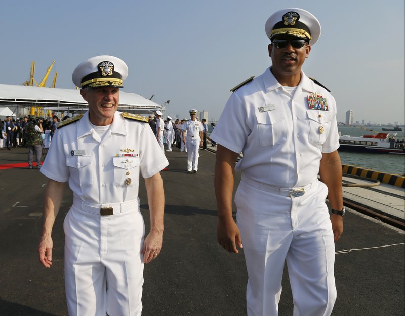 U.S Vice Adm. Phillip Sawyer, commander of the U.S 7th Fleet, and Rear Adm. John Fuller, commander of carrier strike group, walk at Tien Sa port after their press briefing in Danang, Vietnam, Monday, March 5, 2018. For the first time since the Vietnam War, the USS Carl Vinson, a U.S. Navy aircraft carrier, is paying a visit to a Vietnamese port, seeking to bolster both countries' efforts to stem expansionism by China in the South China Sea. (AP Photo/Tran Van Minh)