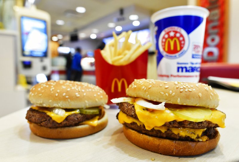 A McDonald's Quarter Pounder, left, and Double Quarter Pound burger are shown with fresh beef Tuesday, March 6, 2018, in Atlanta. McDonald's is offering fresh beef rather than frozen patties in some burgers at thousands of restaurants, a switch it first announced about a year ago as it works to appeal to customers who want fresher foods. (AP Photo/Mike Stewart)