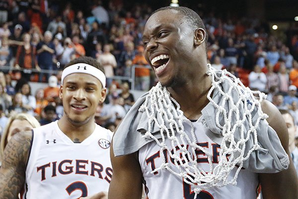 Auburn guard Mustapha Heron, right, wears a basketball net after an NCAA college basketball game against South Carolina, Saturday, March 3, 2018, in Auburn, Ala. (AP Photo/Brynn Anderson)