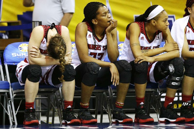 Arkansas State players react dejectedly during the second half of the Red Wolves’ 79-68 loss to Appalachian State on Tuesday in a firstround game of the Sun Belt Conference Tournament at Lakefront Arena in New Orleans. Arkansas State finished 15-15 this season. 