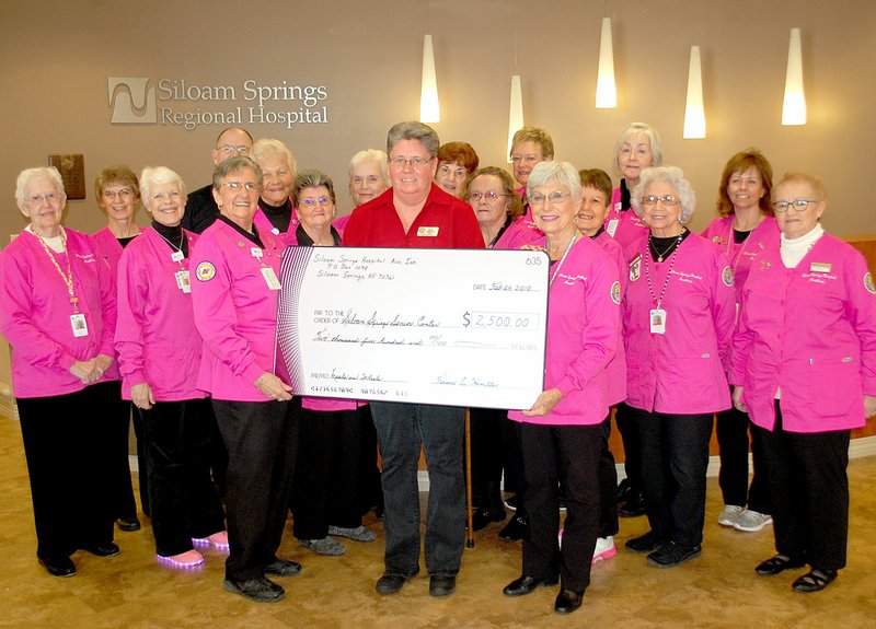 Janelle Jessen/Herald-Leader Siloam Springs Regional Hospital Auxiliary donated $2,500 to the Siloam Springs Senior Activity and Wellness Center's meals on wheels program on Feb. 26.