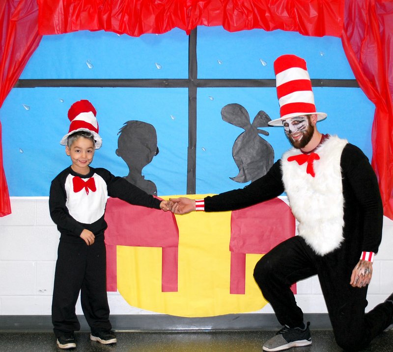 Janelle Jessen/Herald-Leader First-grade student Axel Flores and custodian Michael Rowley were both ready to entertain Sally and her brother from Dr. Suess' famous book The Cat in the Hat.