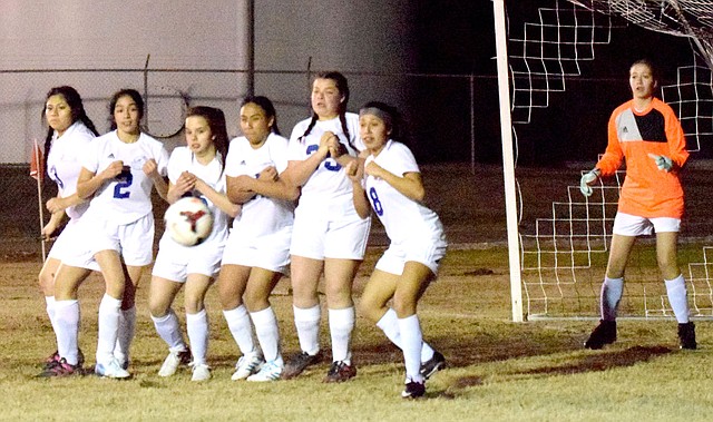 Westside Eagle Observer/MIKE ECKELS Six Lady Bulldogs form a wall to help goalie McKinzee Swaim (right) prevent a Lady Pirate free kick late in the second half of the Decatur-Locust Grove varsity girls' soccer match at Bulldog Stadium in Decatur March 1. The Decatur defensive line includes Maritza Matul (left), Stephanie Sandoval, Abby Tilley, Maria Orellana, Skyler Bell and Heidi Rubi.