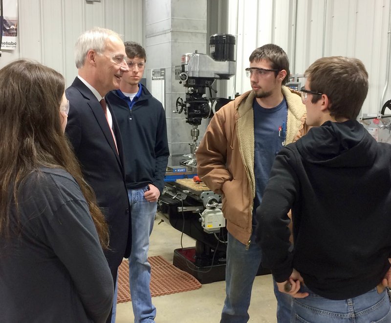 Janelle Jessen/Herald-Leader Gov. Asa Hutchinson visited with a group of Siloam Springs High School students inside the Career Academy of Siloam Springs during his tour of the facility on Monday.