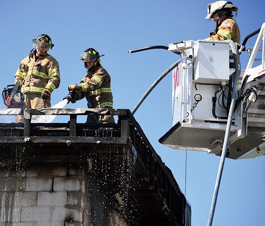 The Sentinel-Record/Grace Brown BARN FIRE: Firefighters with the Hot Springs Fire Department tend to a hot spot and prepare to demolish part of a room of the Swaps Barn on the back side of Oaklawn Park Tuesday. Crews responded to a fire called in at 5:51 a.m. Tuesday in a second-floor tack room. All horses and workers were safely moved away from the fire, which was contained and extinguished within 20 minutes, according to Hot Springs Fire Chief Ed Davis. Oaklawn officials said only two dorm rooms were lost in the blaze.