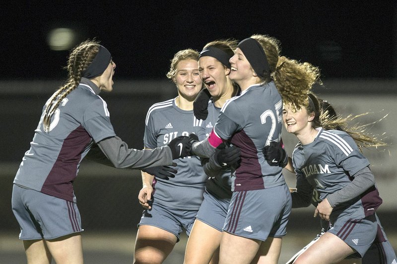 NWA Democrat-Gazette/BEN GOFF @NWABENGOFF Shelby Johnson (from left), Hailey Dorsey, Meghan Kennedy, Megan Hutto and Jaleigh Harp of Siloam Springs celebrate Tuesday after the team's final goal in a victory against Rogers High at Whitey Smith Stadium in Rogers.