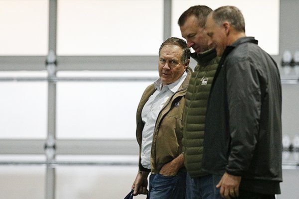 New England Patriots coach Bill Belichick, left, and former Arkansas coach Bret Bielema, center, walk the field during Alabama's Pro Day, Wednesday, March 7, 2018, in Tuscaloosa, Ala. The event is to showcase players for the upcoming NFL football draft. (AP Photo/Brynn Anderson)

