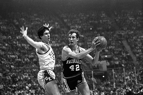 Rick Robey of Kentucky, left, flails his arms as Jim Counce (42) of Arkansas tries to pass during semifinal NCAA action in St. Louis, Mo., March 25, 1978. (AP Photo)

