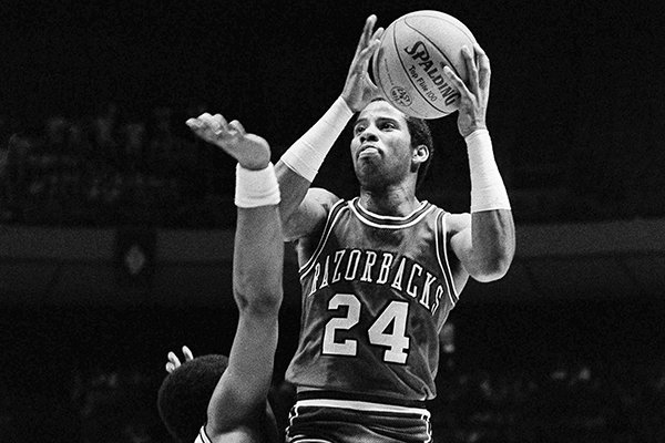 Arkansas’ U.S. Reed (24), jumps to sink a basket as Louisville’s Rodney McCray (22) attempts a block in this first half action from their second round, Midwest regional NCAA Playoff Game at Austin, Texas, on Saturday, March 14, 1981. Later in the game, with one second to play, Reed sank a half-court shot to win the game for Arkansas, 74-73. (AP Photo/Cooper)

