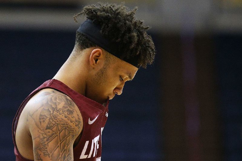 UALR freshman guard Cameron Corcoran leaves the floor Wednesday after the Trojans’ loss to Appalachian State in the first round of the Sun Belt Conference Tournament in New Orleans. UALR ended the season 7-25. 